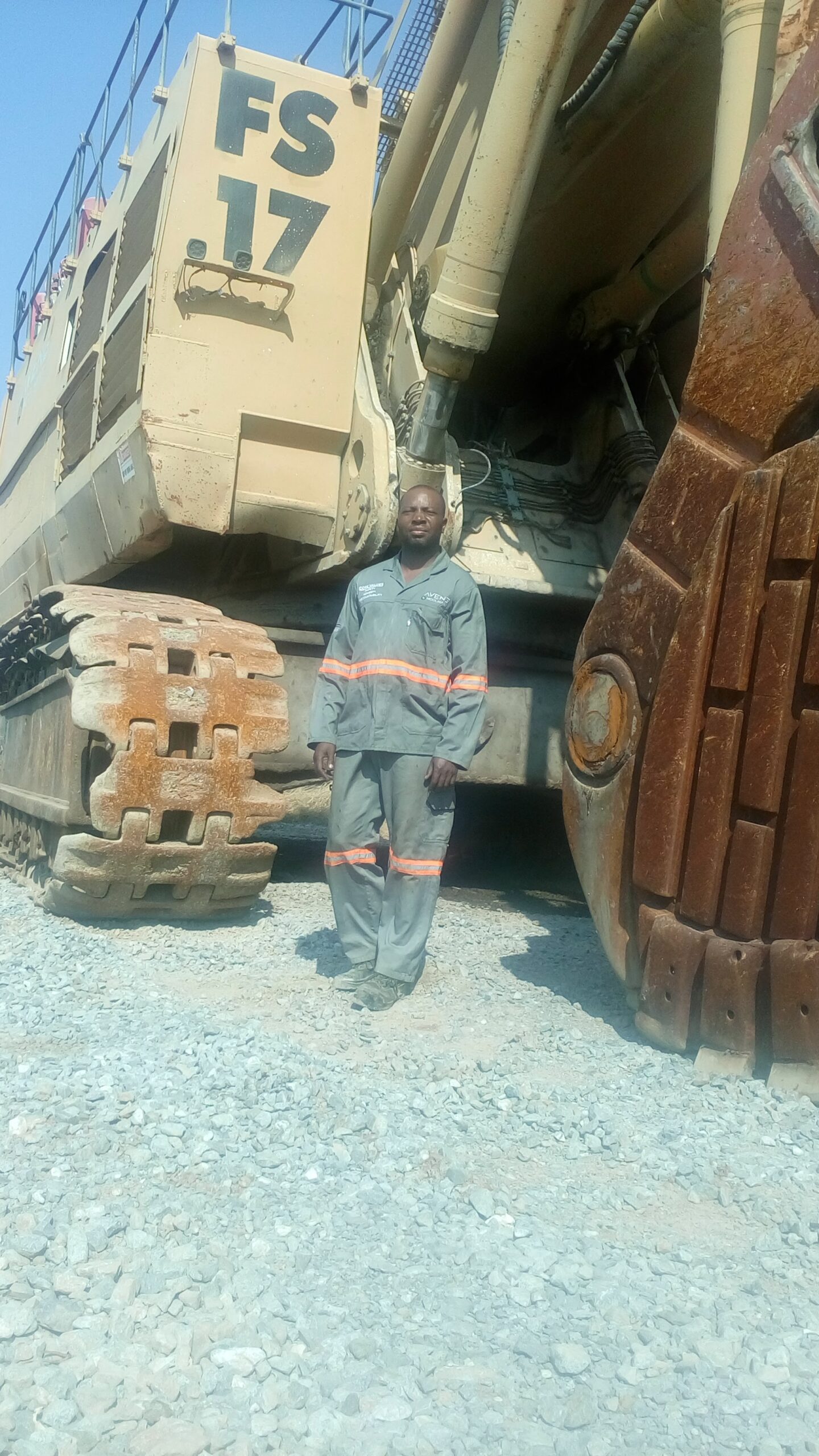 Instructor Quest Mhandu standing besides a face shovel